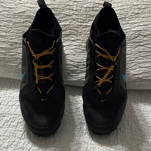 Nike Vapormax Black Sneakers with Yellow Laces and Blue Accents.